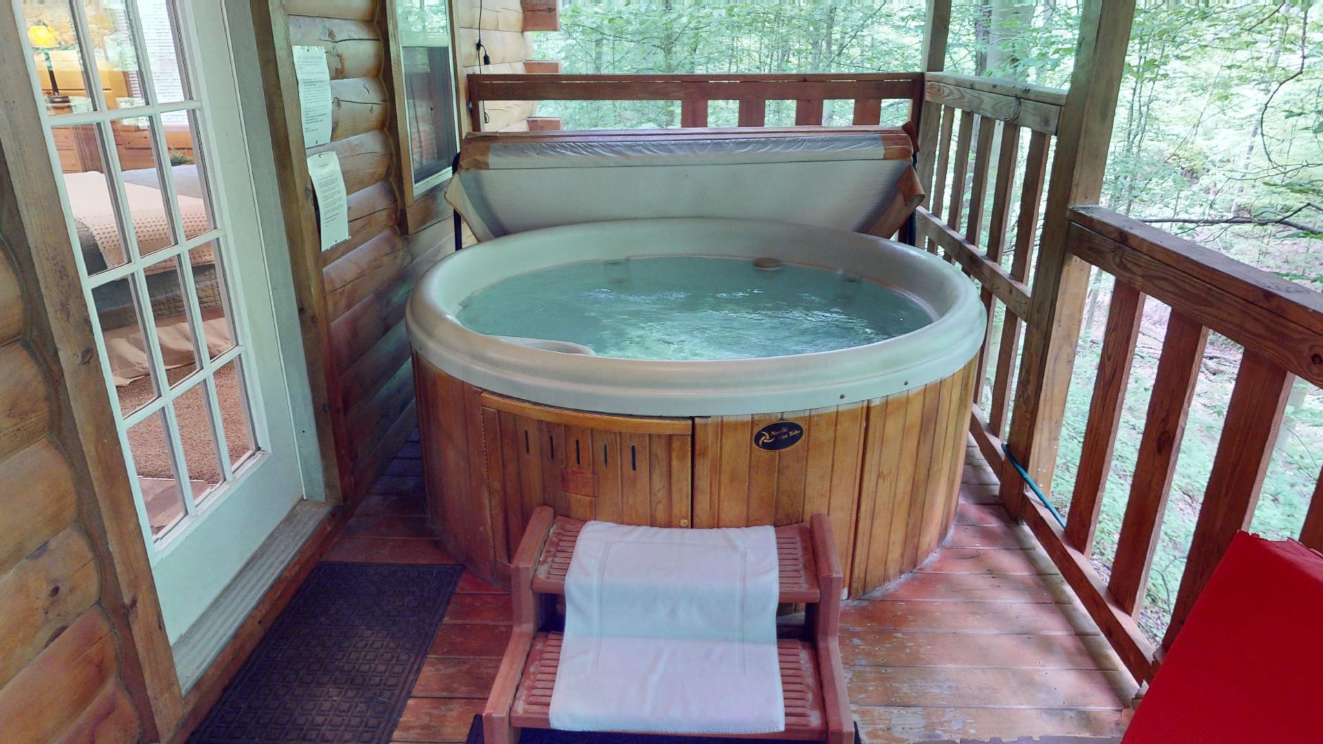 Private hot tub on the covered deck at Aspen Cabin