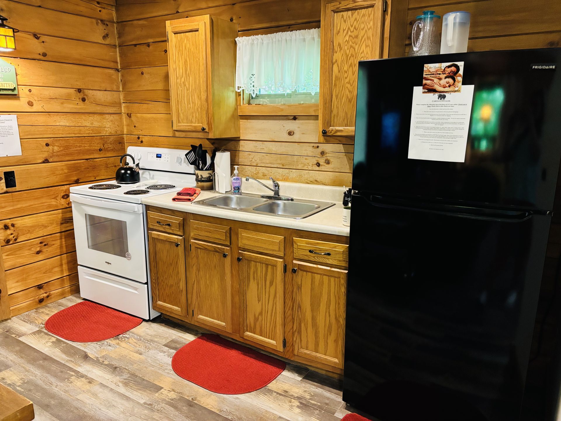 Full kitchen with range, sink and full-size refrigerator at Aspen Cabin