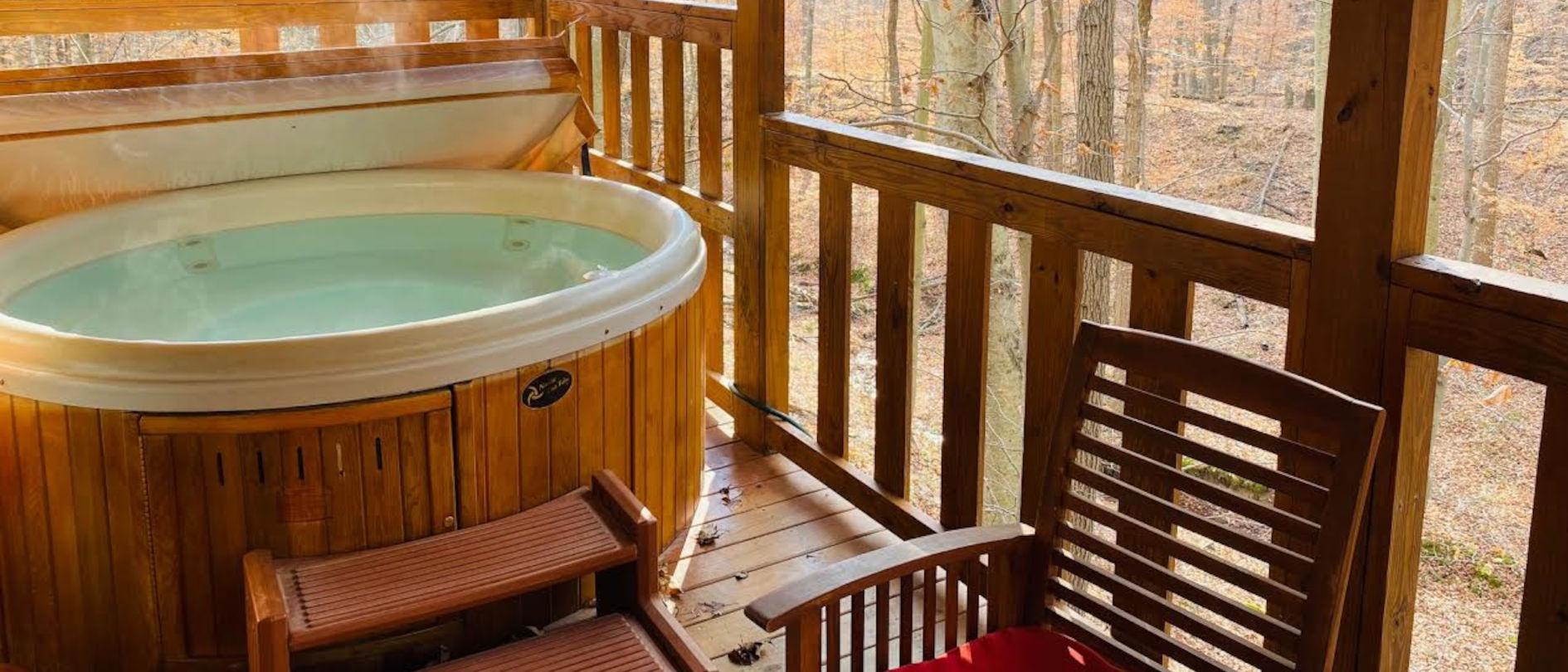 A private hot tub on a paver patio at dusk