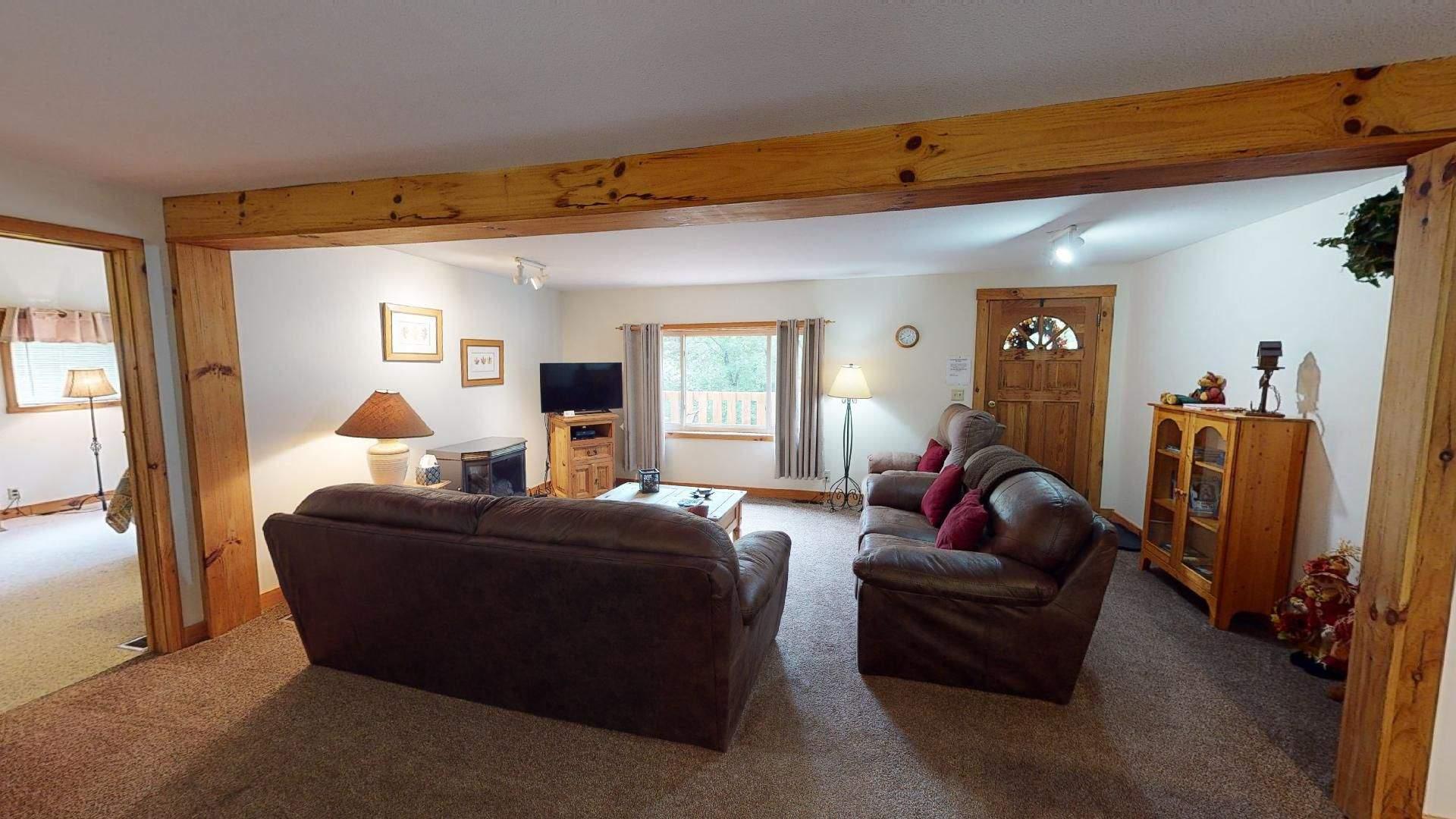 The open living area at Red Oak Cabin under exposed pine beams