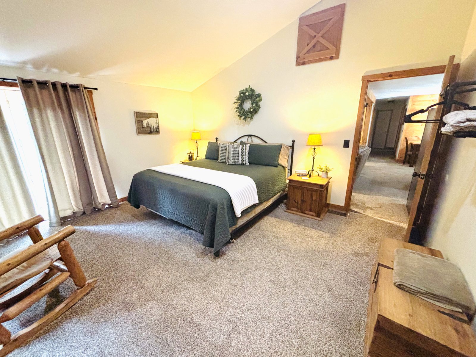 Second bedroom at Red Oak Cabin, with a king bed, television and bunk beds