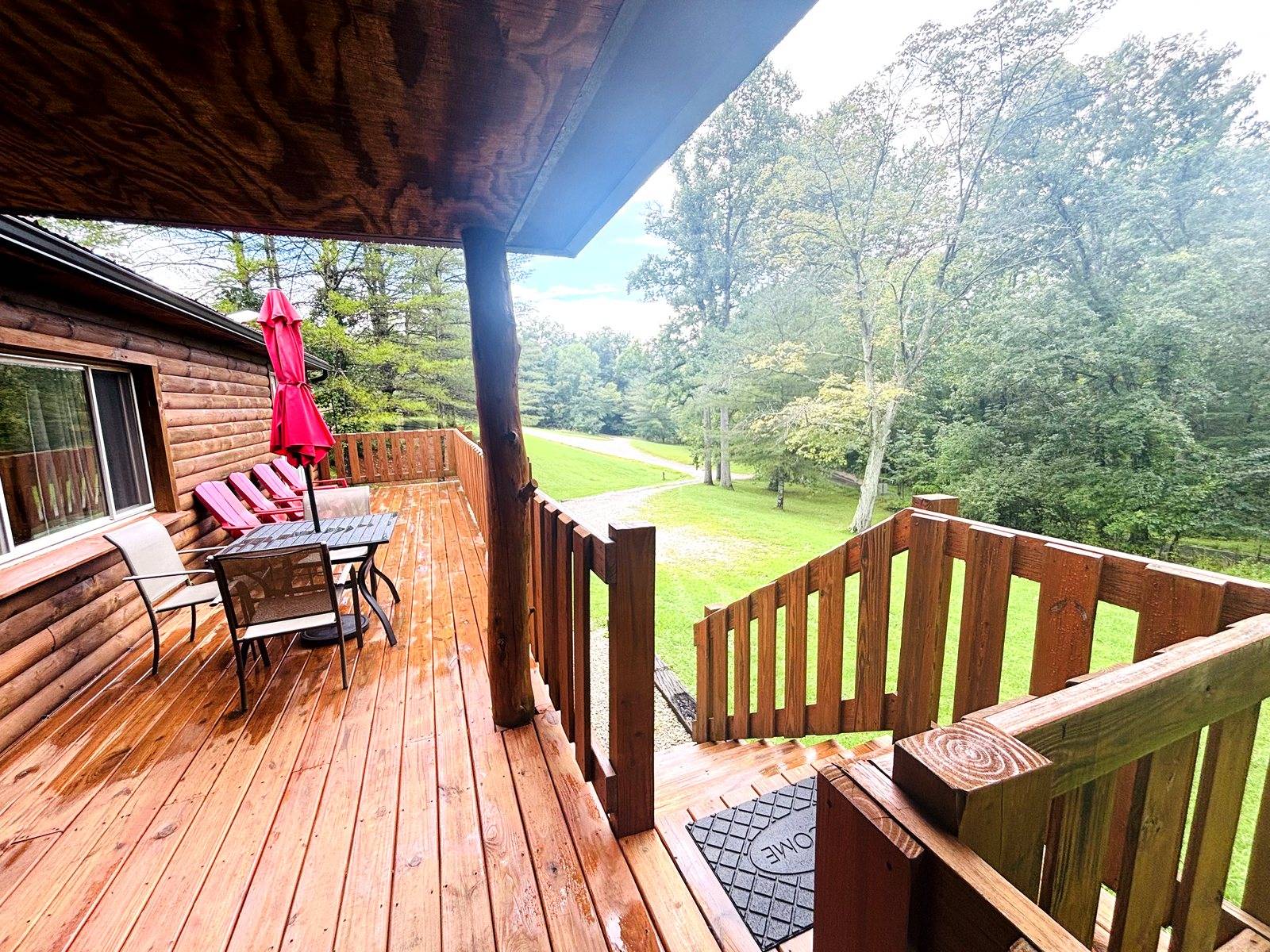 The covered deck at Red Oak Cabin, looking down the lawn