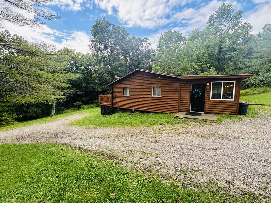 Red Oak Cabin at Bear Run, seen across the lawn from the picnic shelter on a clear day