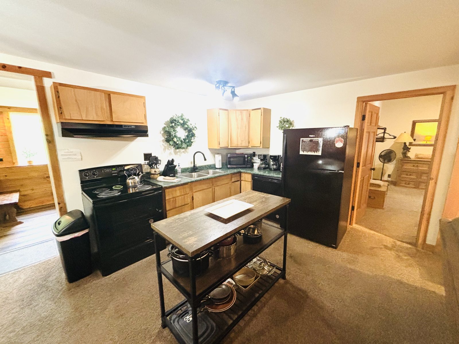 Full kitchen at Red Oak Cabin with a range, dishwasher, full-size refrigerator and a prep island