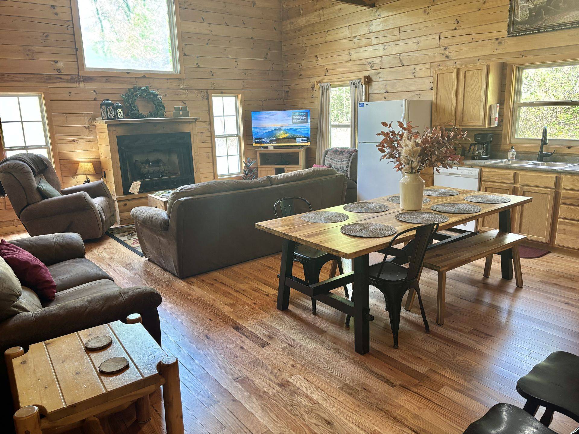 Open living room, dining table and kitchen at Redbud Cabin