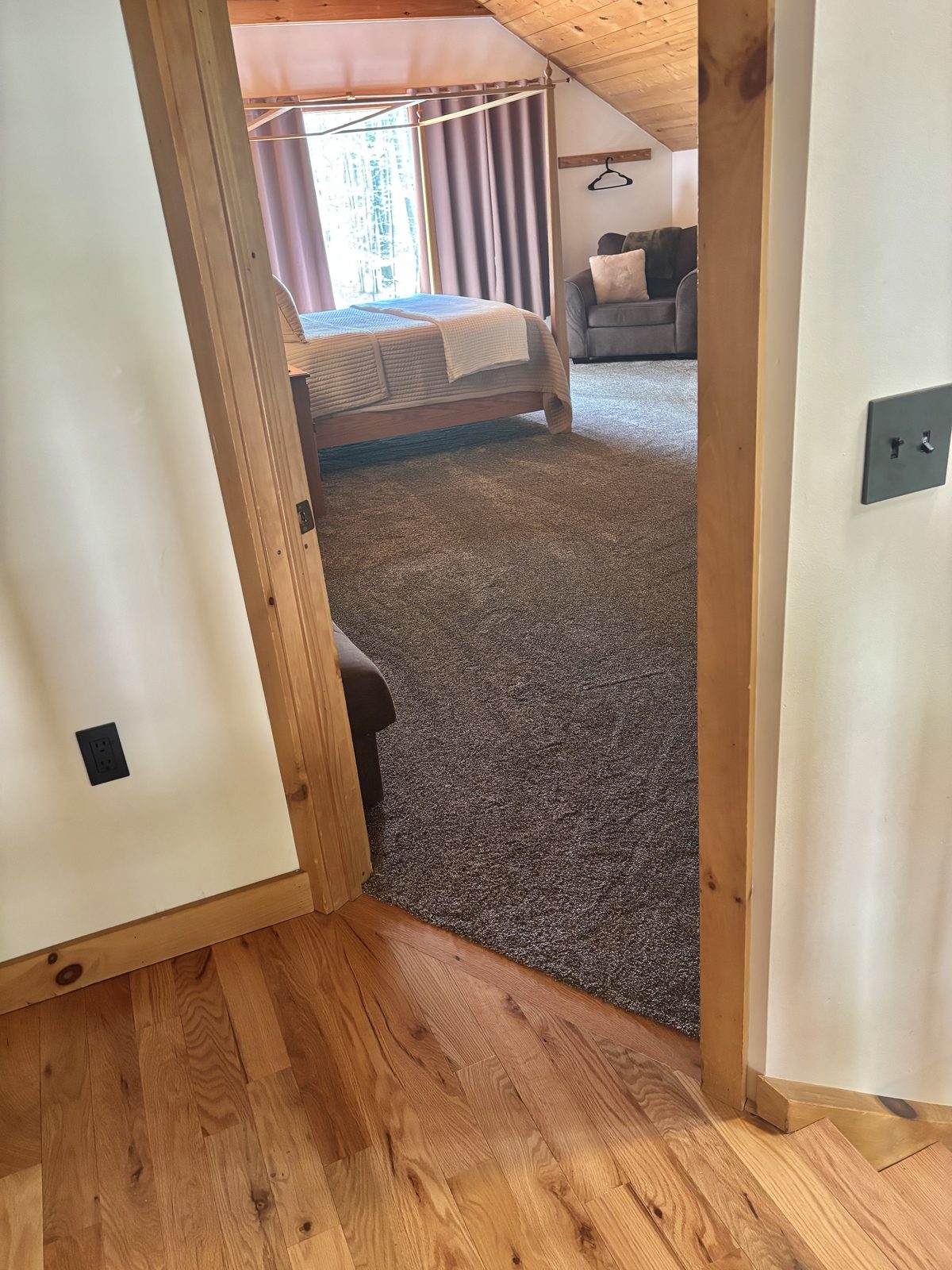 Looking through the doorway into the upstairs master suite at Redbud Cabin